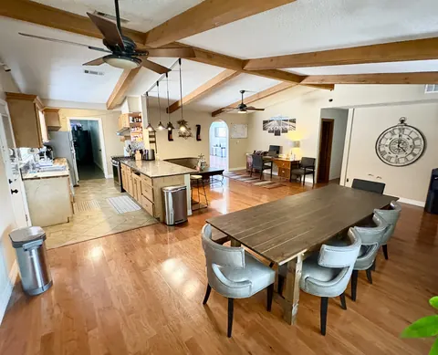 Open dining room and kitchen with a long shared table