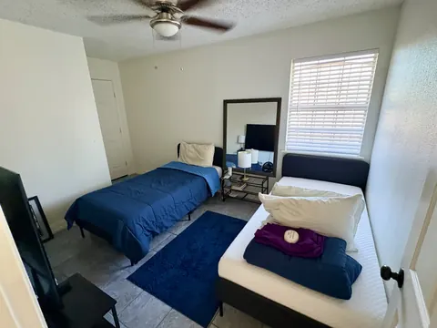 Shared bedroom with two twin beds and natural light