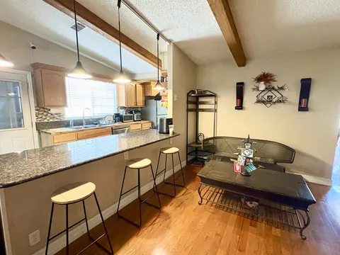 Kitchen breakfast bar with stools and seating area