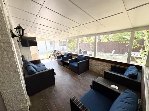 Covered back patio with lounge seating and fenced yard