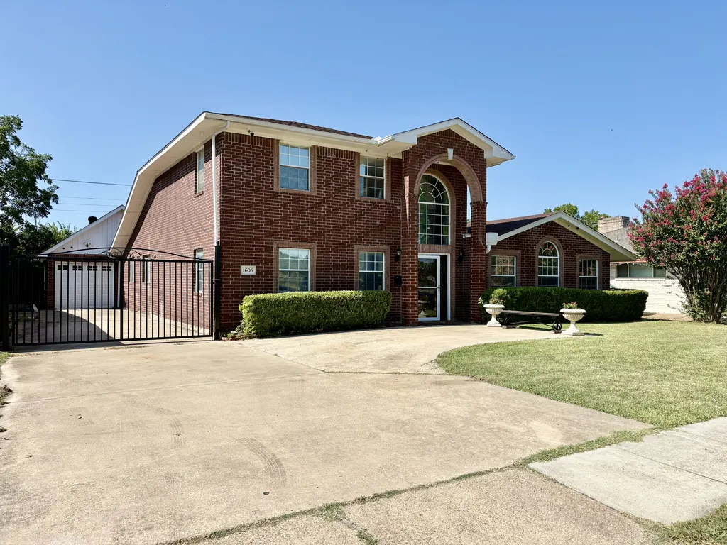 Front exterior of Directions Sober Living House — brick two-story at 1606 Addington St, Irving, TX