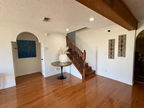 Entry hall and staircase with hardwood floors