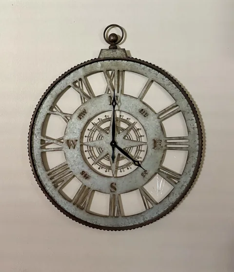 Compass wall clock — the Directions motif inside the house