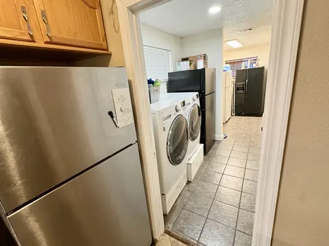 On-site laundry room with washer, dryer and refrigerators